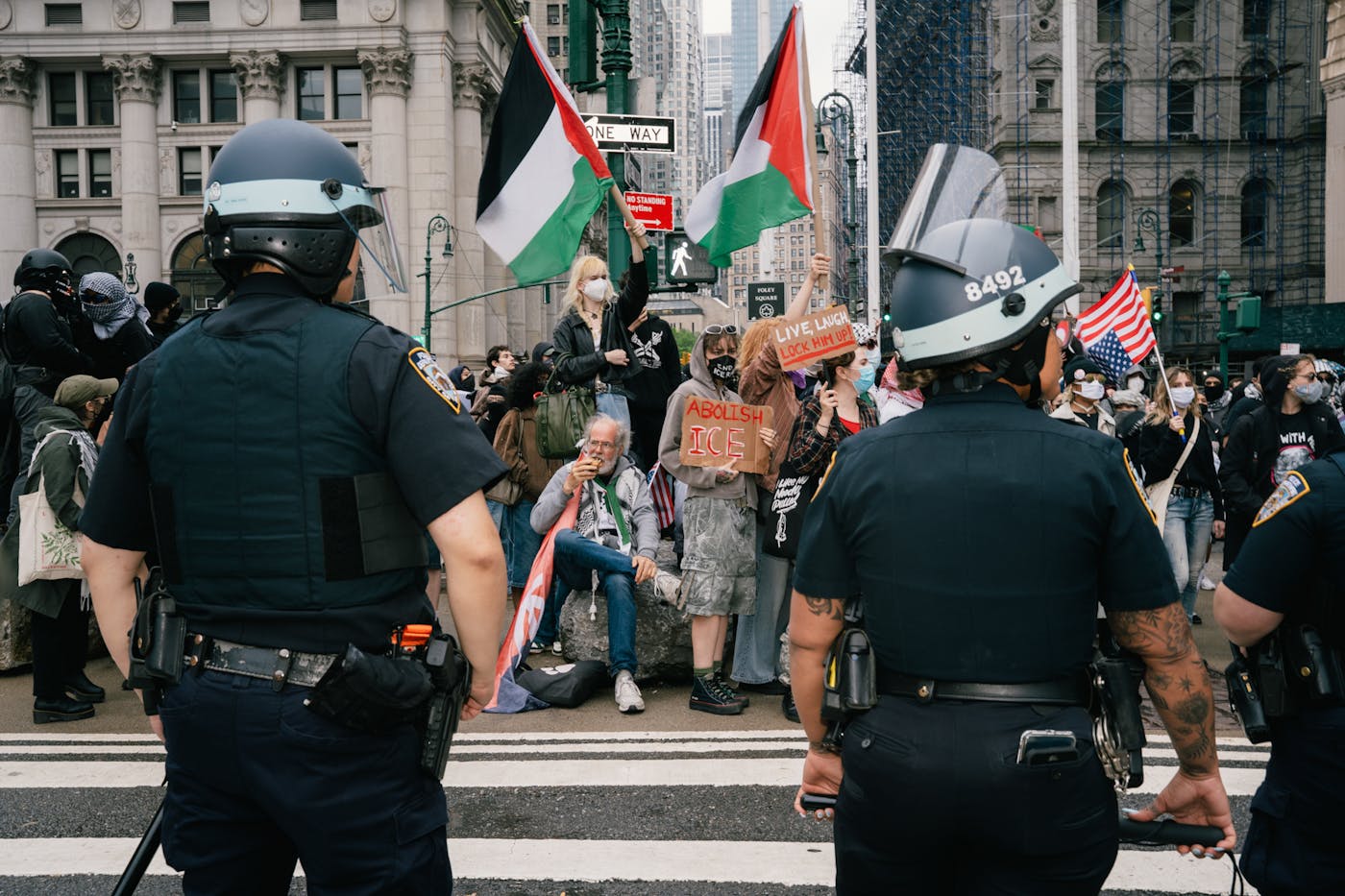 Police look accross a street to protesters in New York City on Sunday at the No Kings event 