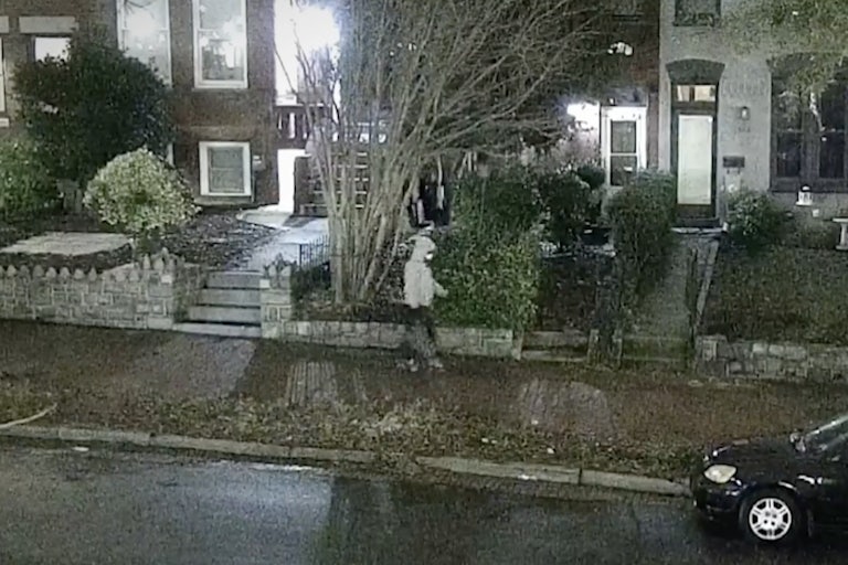 Jan. 5 pipe bombing suspect wears a gray hoodie and a face mask and walks in the streets of Washington, D.C. carrying a bag.