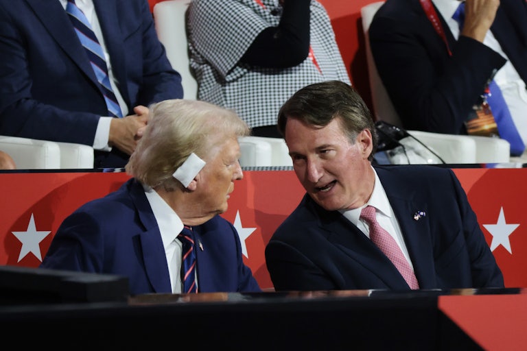 Donald Trump and Glenn Youngkin sit next to and talk to each other at the Republican National Convention