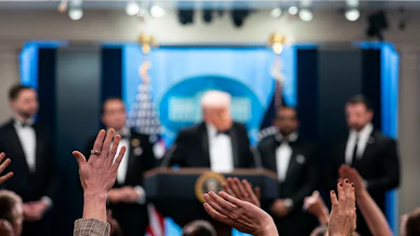 Reporters and members of the media raise their hand to ask a question to President Donald Trump during a press conference in the Brady Briefing Room of the White House following the cancellation of the annual White House Correspondents Association Dinner.