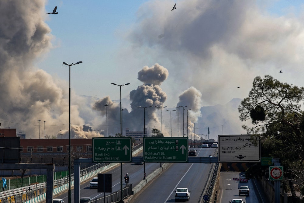 Plumes of smoke billow over a highway.