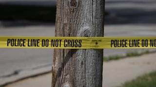 Police tape in front of a tree