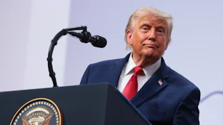 Donald Trump smiles while speaking at the G7 summit.