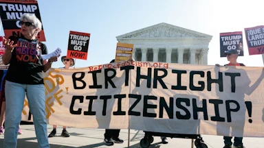 Demonstrators hold signs in support of birthright citizenship outside the Supreme Court.