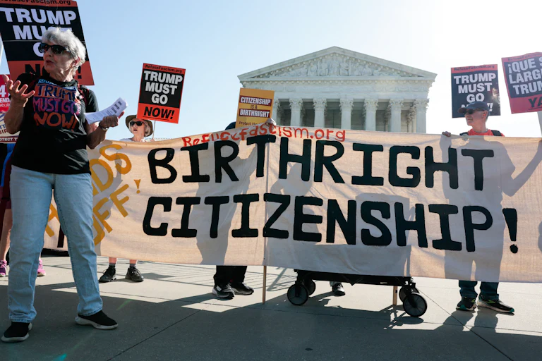 Demonstrators hold signs in support of birthright citizenship outside the Supreme Court.