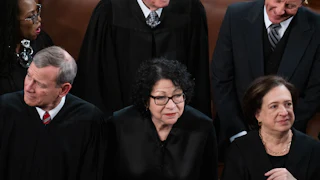 Sonia Sotomayor stands in the middle of Elena Kagan, right, and John Roberts. All are wearing black.