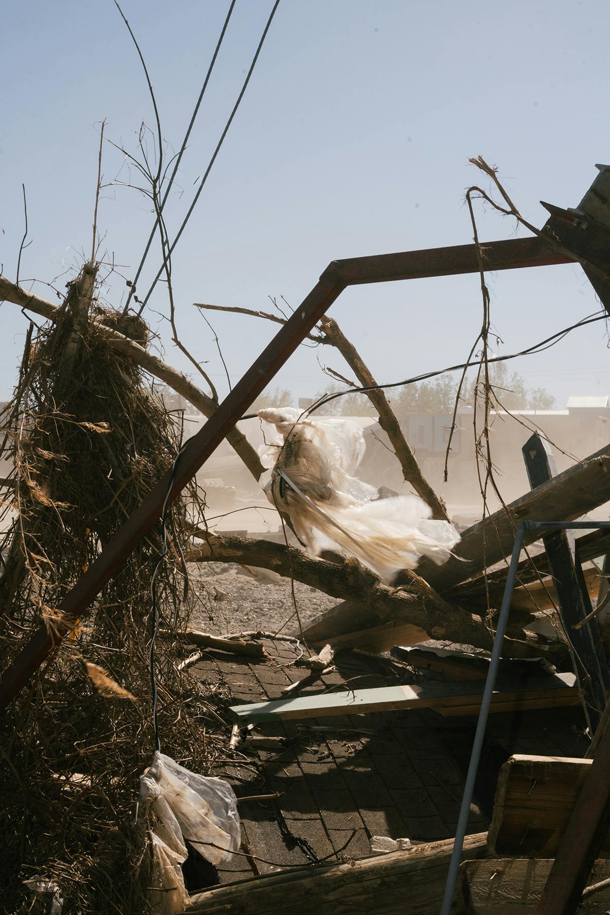 A photograph of twisted debris—metal, plastic, tree branches, asphalt shingles, and cables—came to rest in Asheville’s River Arts District, home to hundreds of artists and designers and their studios.