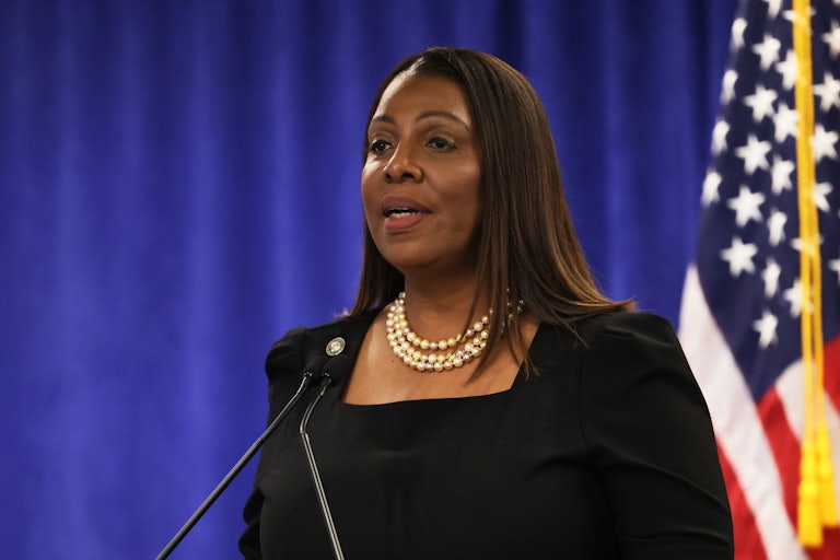 Letitia James speaks at a mic. A U.S. flag is in the background.