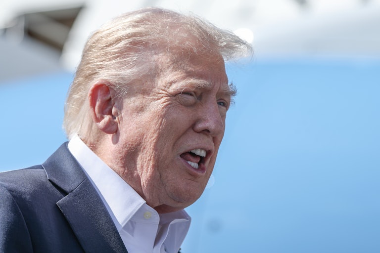 Donald Trump speaks to reporters while standing next to Air Force One