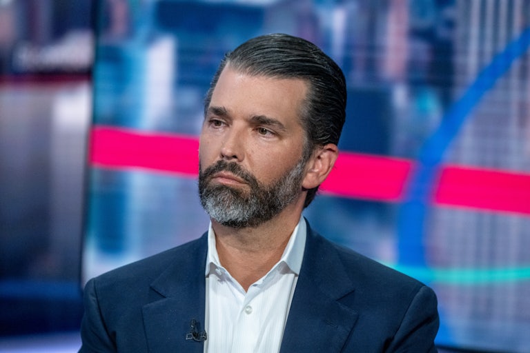 Donald Trump Jr. sits on a television set