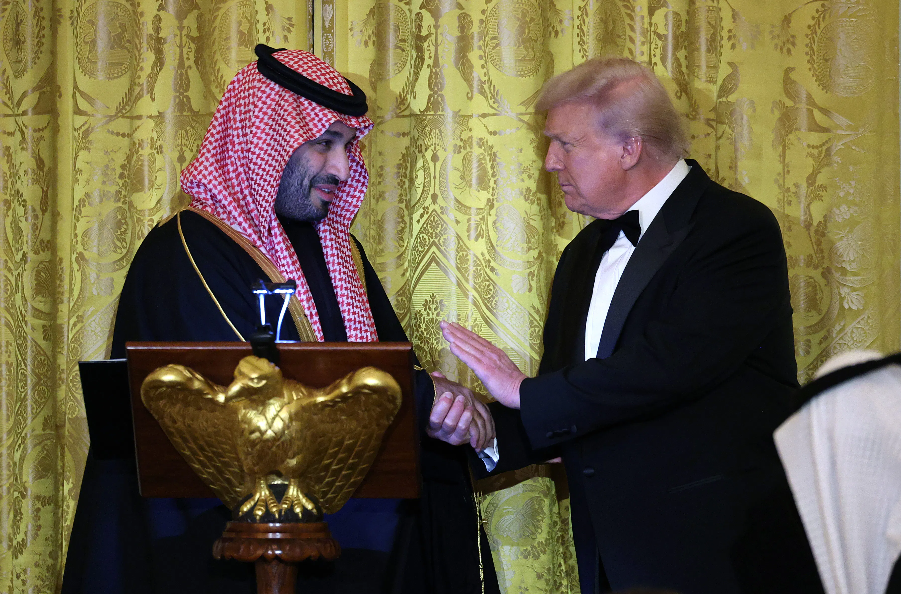 Saudi Crown Prince Mohammed bin Salman of Saudi Arabia and U.S. President Donald Trump shake hands while on stage.