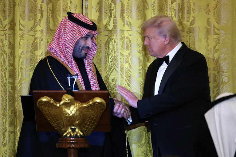 Saudi Crown Prince Mohammed bin Salman of Saudi Arabia and U.S. President Donald Trump shake hands while on stage.