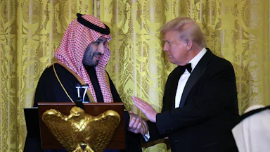 Saudi Crown Prince Mohammed bin Salman of Saudi Arabia and U.S. President Donald Trump shake hands while on stage.
