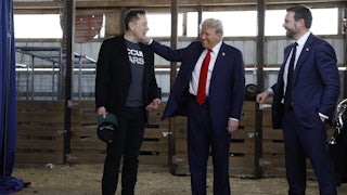 President Donald Trump visits with Elon Musk and JD Vance back stage during a campaign rally.