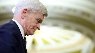 Bill Cassidy with his head pointed downward.