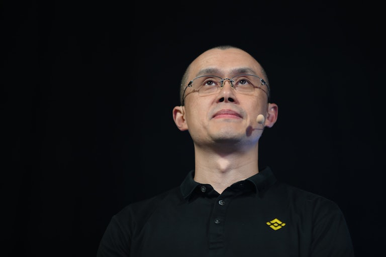 Changpeng Zhao, co-founder & CEO of Binance, wears a mic headset and a black T-shirt.