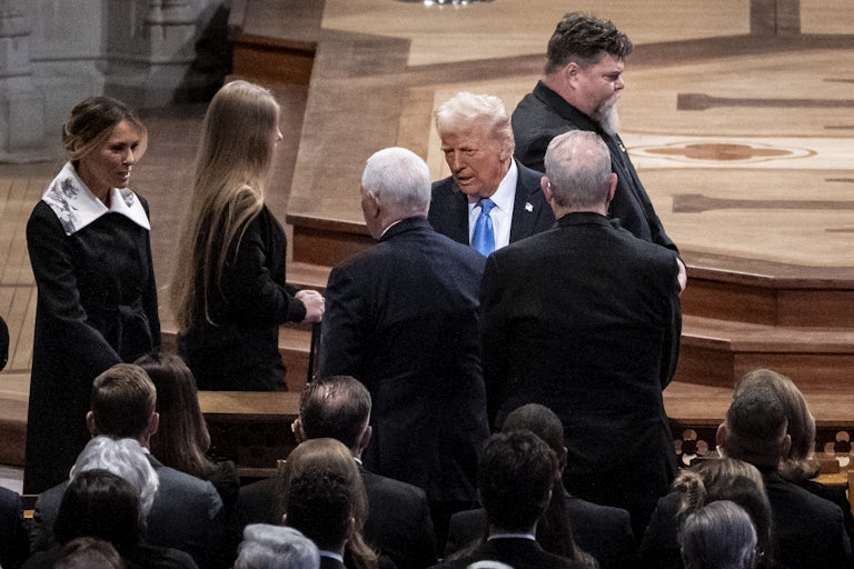Donald Trump and Melania Trump are seen talking to Mike Pence, as all three stand in the cathedral pews.