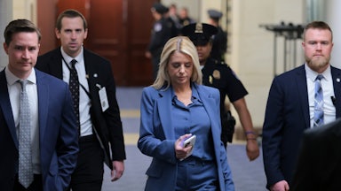 Attorney General Pam Bondi walks through Capitol Hill along with three men and a police officer.