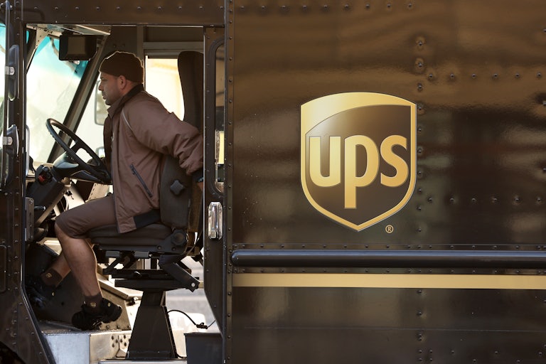 A driver sits in his UPS truck.