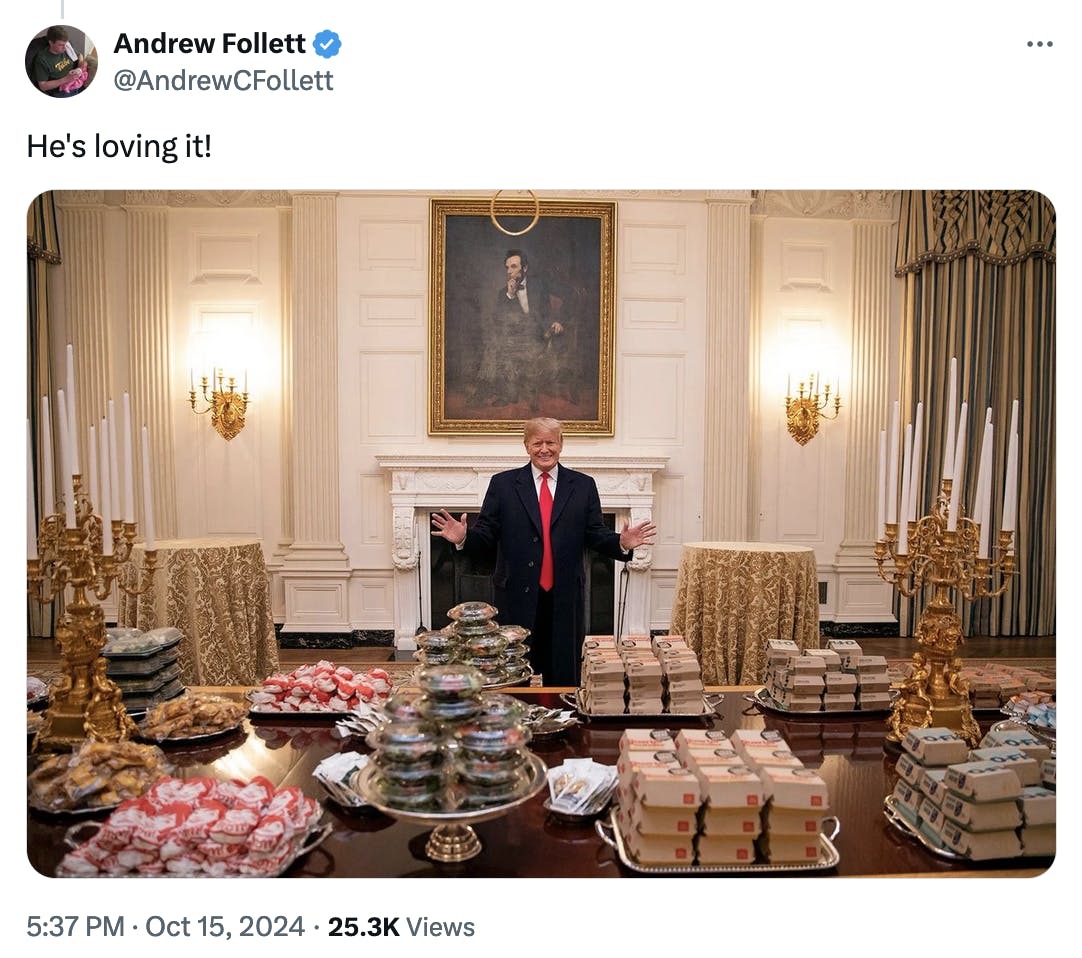 Twitter screenshot Andrew Follett @AndrewCFollett: He's loving it! (photo of Trump at the White House with so much McDonald's food on the table in front of him)