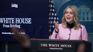 Karoline Leavitt gestures while speaking at the podium in the White House press briefing room