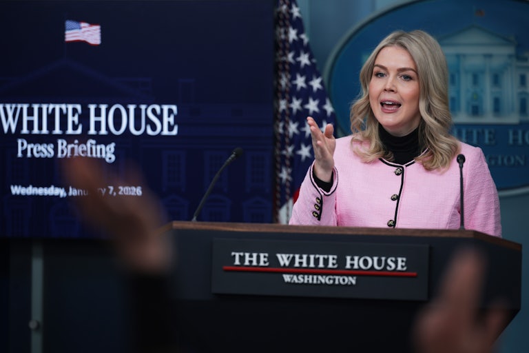 Karoline Leavitt gestures while speaking at the podium in the White House press briefing room