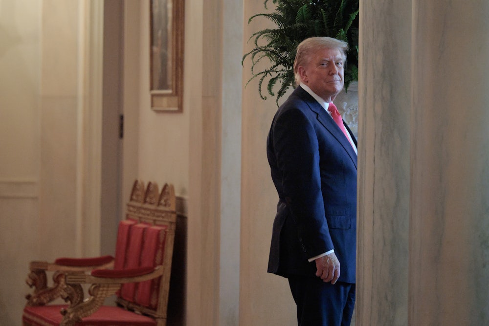 Donald Trump smiles as he walks into a doorway