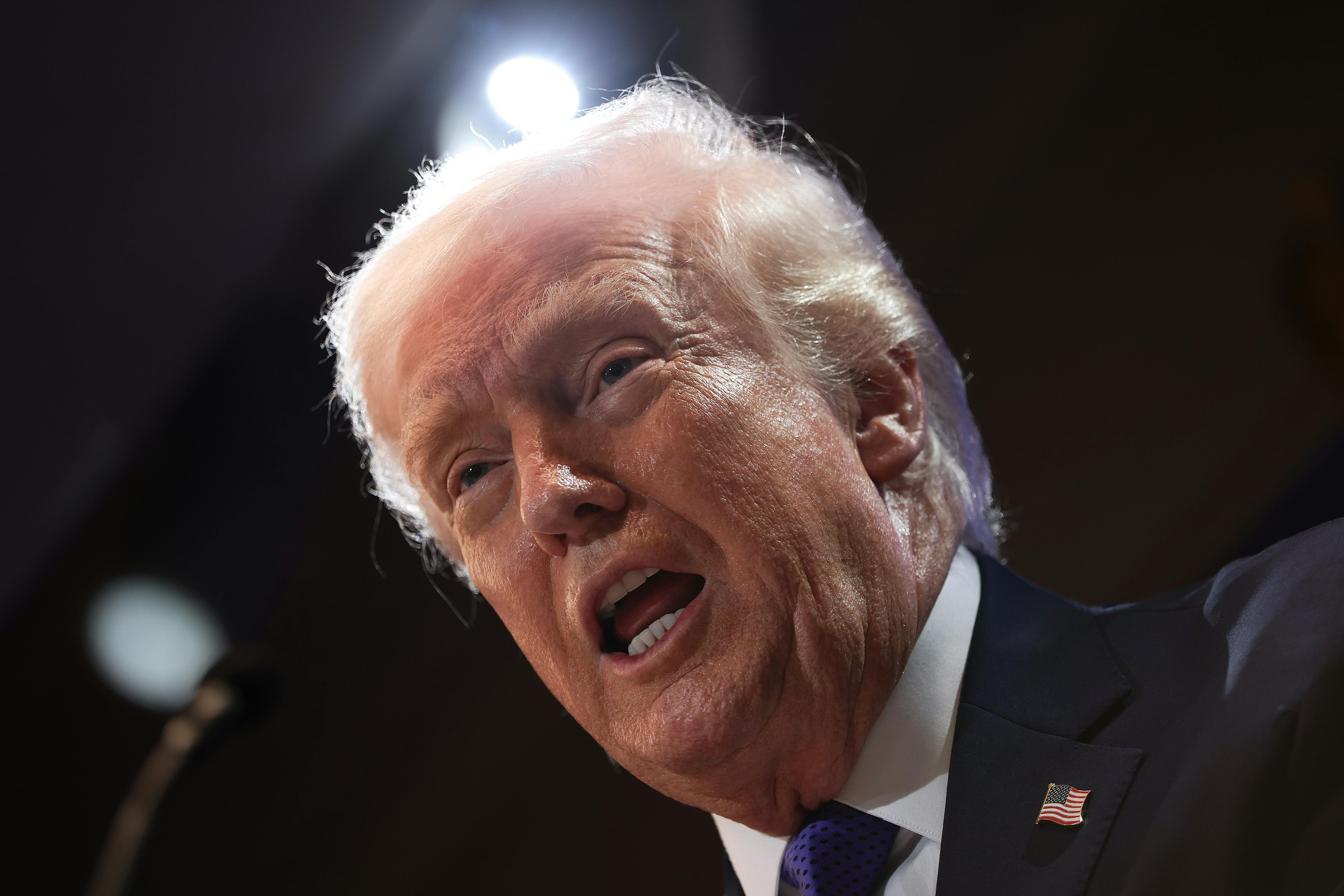 Donald Trump speaks into a microphone