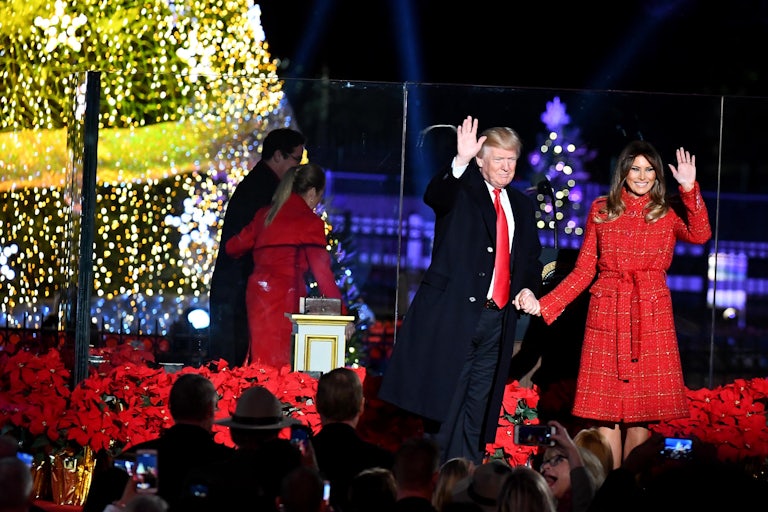 Donald Trump and Melania Trump wave near a the national Christmas tree