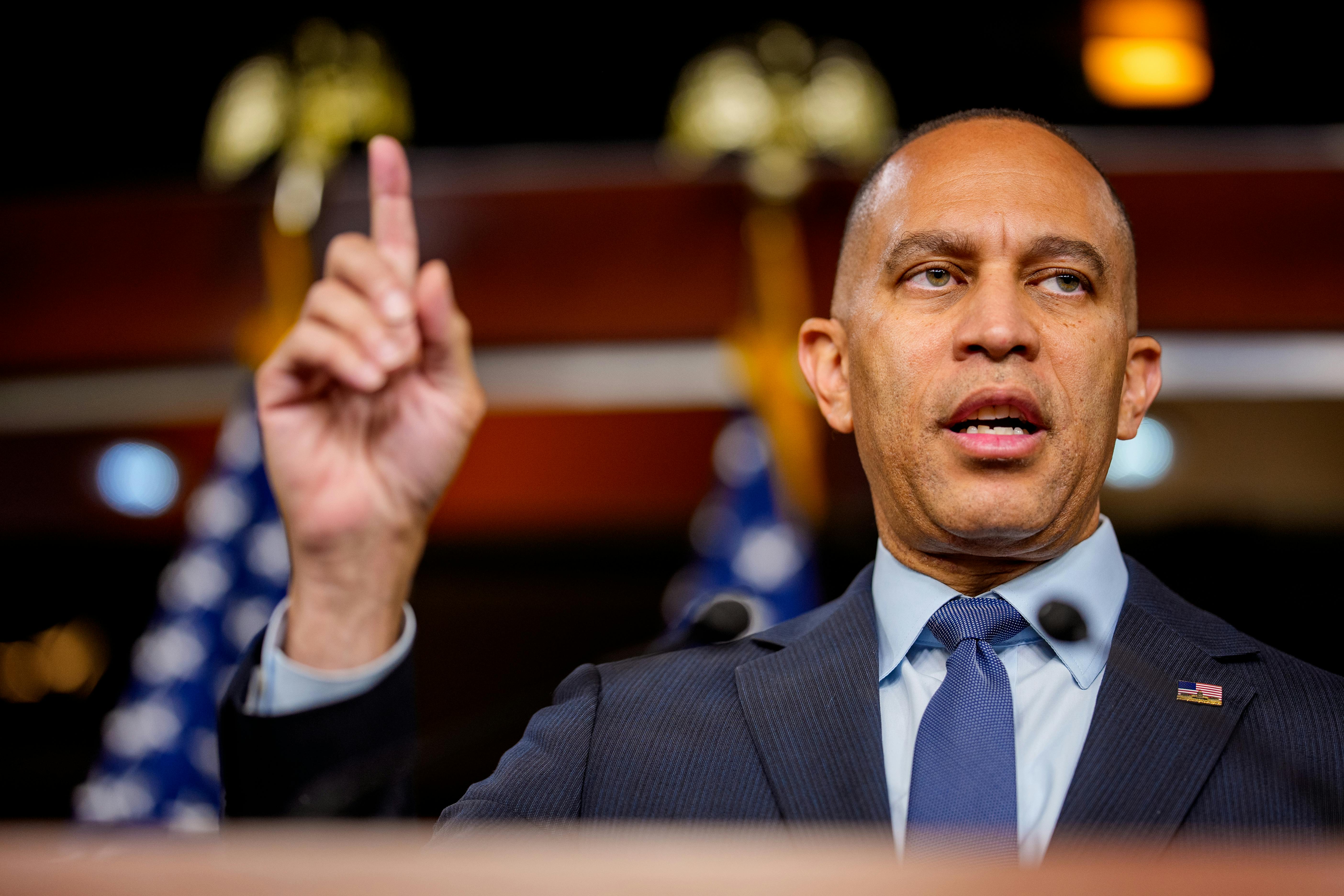 House Minority Leader Hakeem Jeffries raises his finger while speaking during a press conference