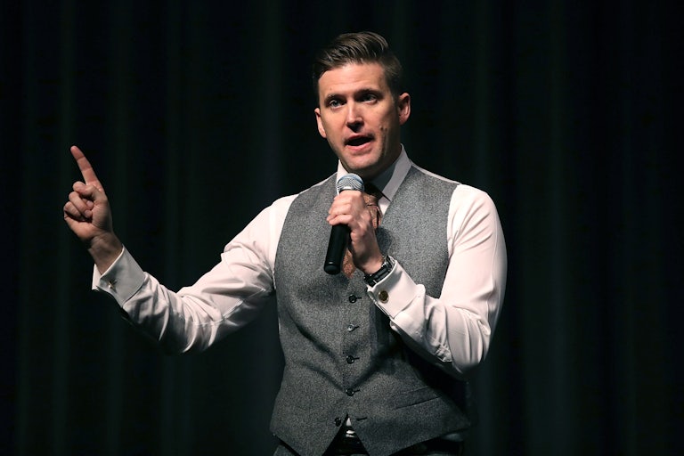 Richard Spencer speaks on a mic and points