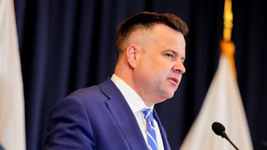 Acting Director of National Intelligence Bill Pulte speaks at a podium.