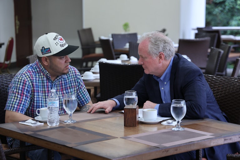 Kilmar Abrego García and Senator Chris Van Hollen sit next to each other at a table