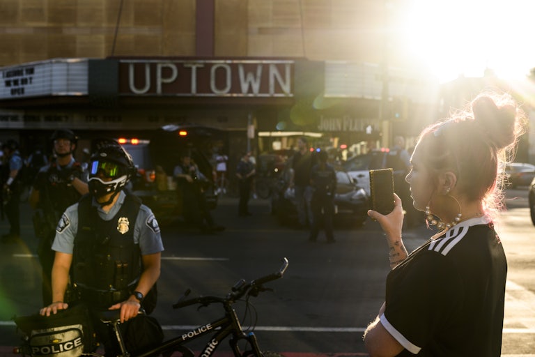 woman and Minneapolis Police officer at protest
