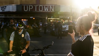 woman and Minneapolis Police officer at protest