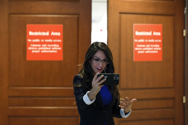 Lauren Boebert films a video fo herself outside a room presumably in the Capitol. Both closed doors say "Restricted area."