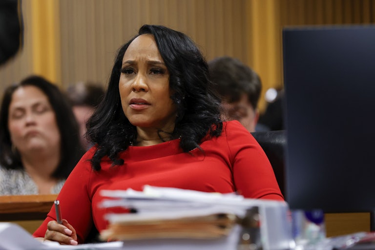 Fani Willis sits in court and furrows her brows, looking confused or mad