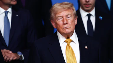 Donald Trump stands during an official photo at the NATO summit.