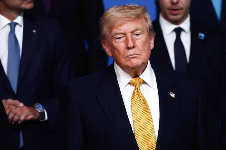 Donald Trump stands during an official photo at the NATO summit.