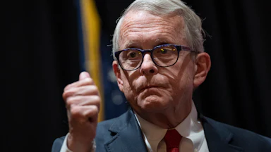 Ohio Governor Mike DeWine makes a fist as if emphasizing a point.