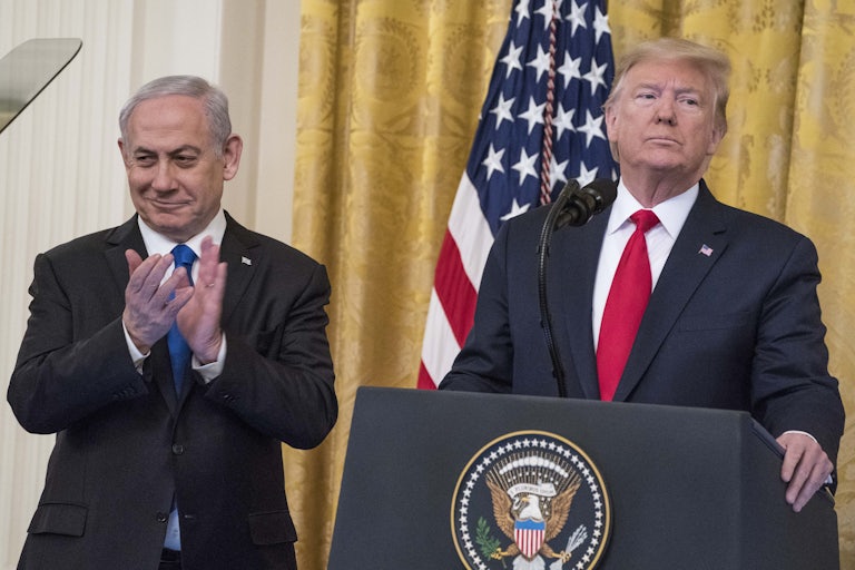 Donald Trump, standing behind the White House lectern, and Benjamin Netanyahi standing side by sid