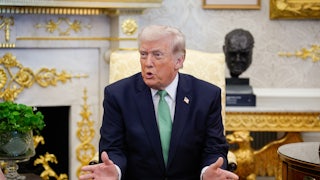 Donald Trump speaks while sitting in his golden Oval Office.