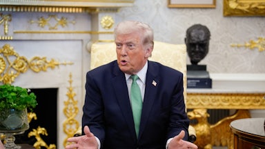 Donald Trump speaks while sitting in his golden Oval Office.