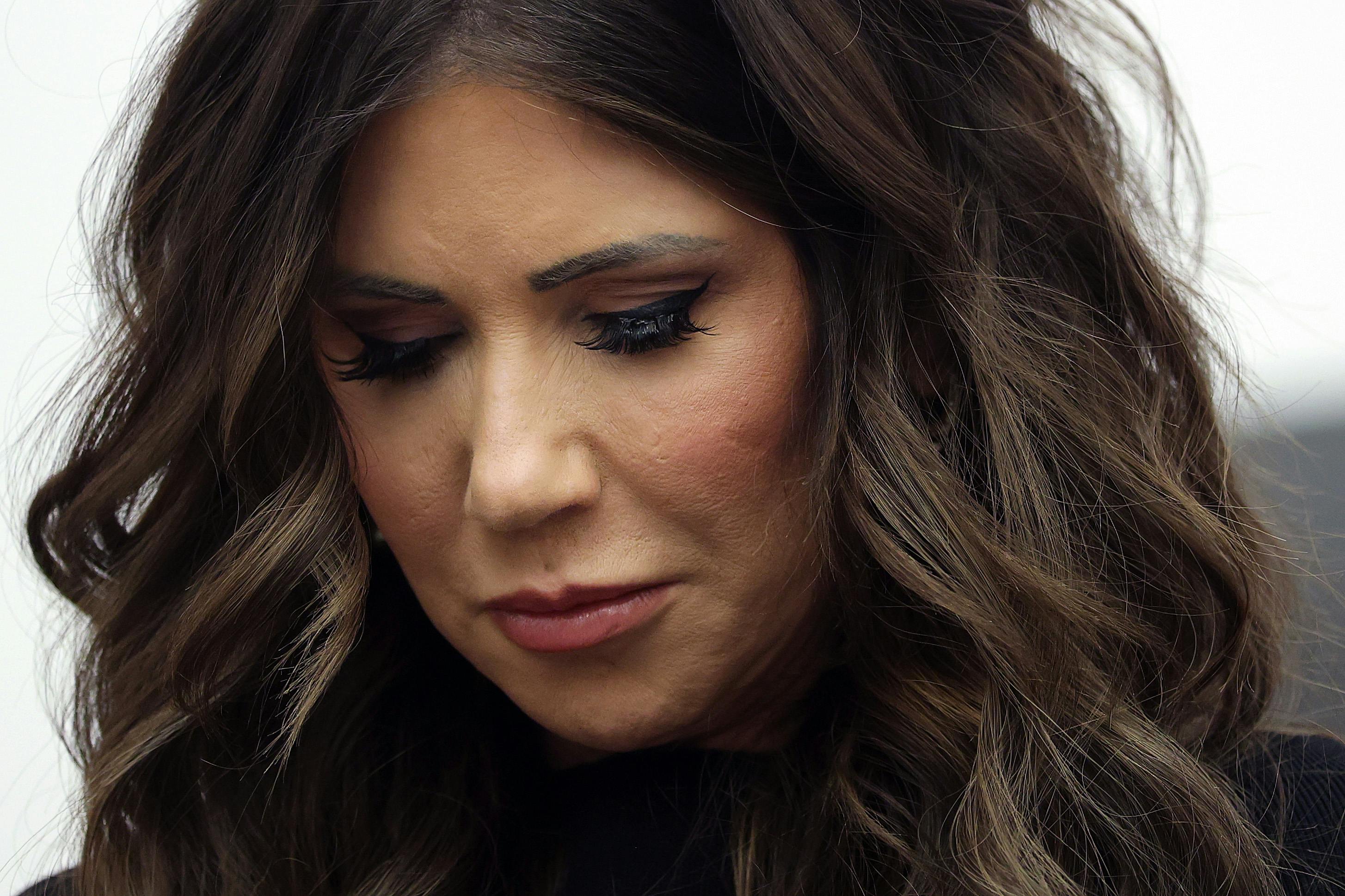 Homeland Security Secretary Kristi Noem looks downcast