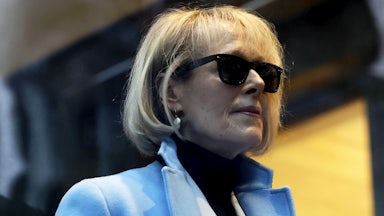 E. Jean Carroll wears sunglasses and a light blue blazer