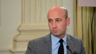 Stephen Miller sits in front of a microphone during an event at the White House