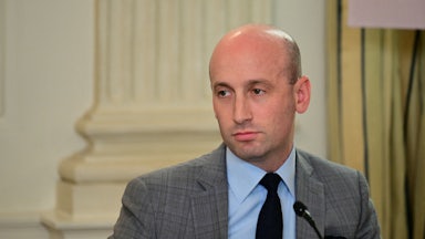 Stephen Miller sits in front of a microphone during an event at the White House