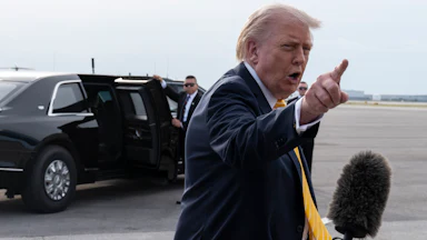Donald Trump points and yells at a reporter (not pictured)