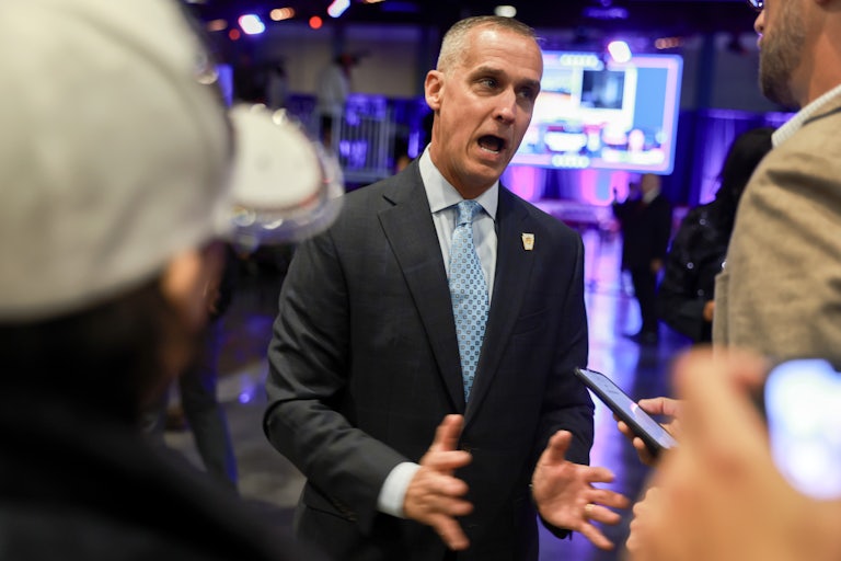 Corey Lewandowsi talks animatedly with reporters