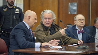 Steve Bannon speaks to his attorney in court.